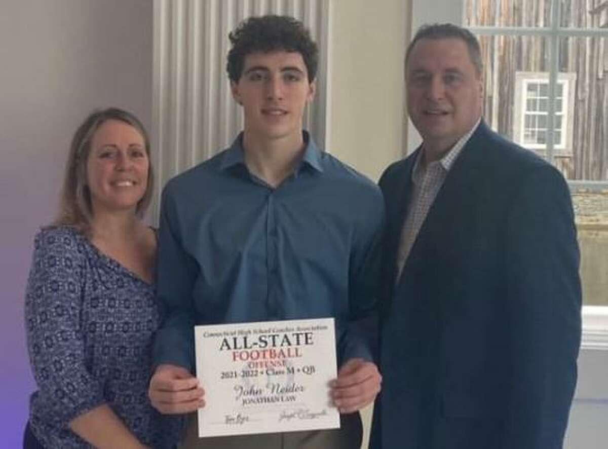 Jonathan Law junior quarterback and captain John Neider was honored at the Connecticut High School Coaches’ Association All State banquet. Neider is flanked by mom Kelly and dad John.