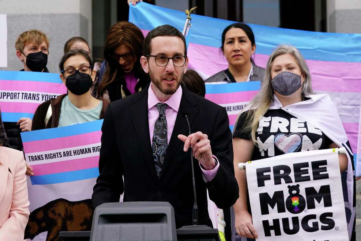 State Sen. Scott Wiener, D-San Francisco, discusses his proposed measure to provide legal refuge to displaced transgender youth and their families during a news conference in Sacramento, Calif., Thursday, March 17, 2022. If approved the measure, that responds to several states, particularly Texas, aims to protect parents from having their transgender children taken away from them or from being criminally prosecuted for supporting their children's access to healthcare, including gender-affirming care. (AP Photo/Rich Pedroncelli)