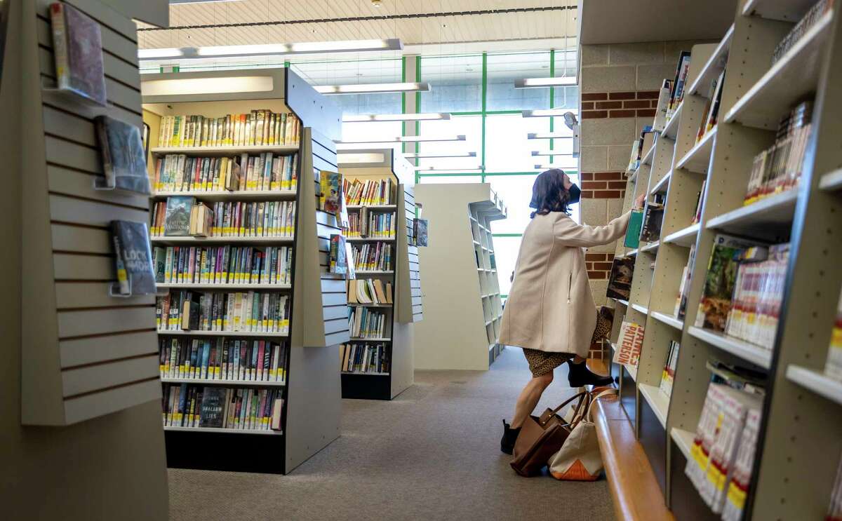 Hull looks for books for her students at a public library in Lancaster County, Pa.