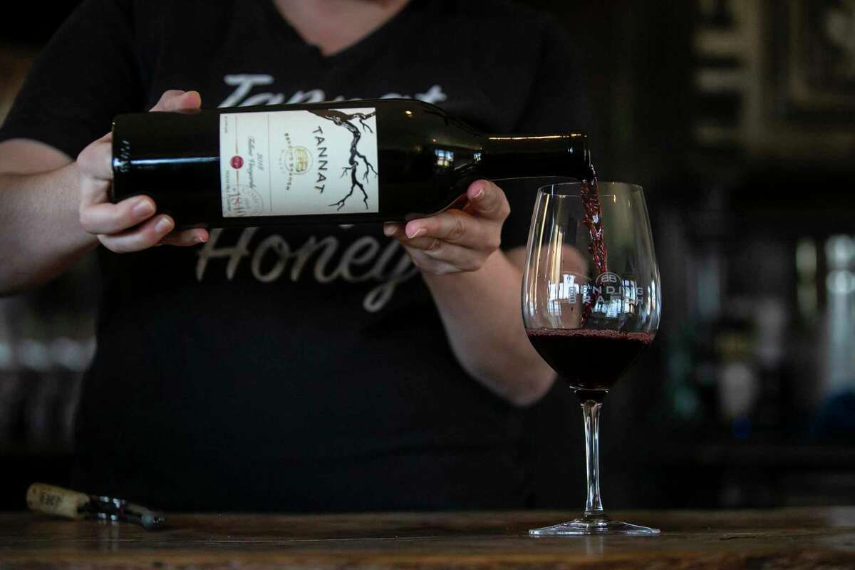 Erin Shields pours a glass of tannat at the Bending Branch Winery in Comfort. Hill Country wineries have exploded in popularity in the past decade, with permits up 625 percent.