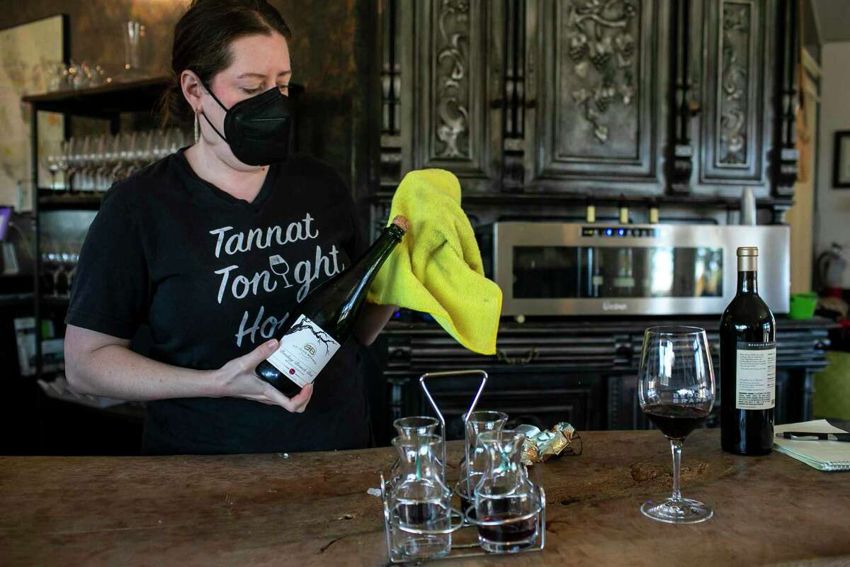 Erin Shields opens a bottle for tasting at Bending Branch Winery in Comfort. Hill Country wineries have exploded in popularity over the past decade, with winemakers flocking to the area because of its growing environment, views and the tourism market for wine consumption.