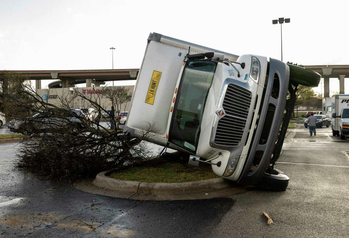 A truck is knocked on its side after a tornado hit a shopping center near I-35 and SH 45 in Round Rock, Texas, on Monday, March 21, 2022. (Jay Janner/Austin American-Statesman via AP)