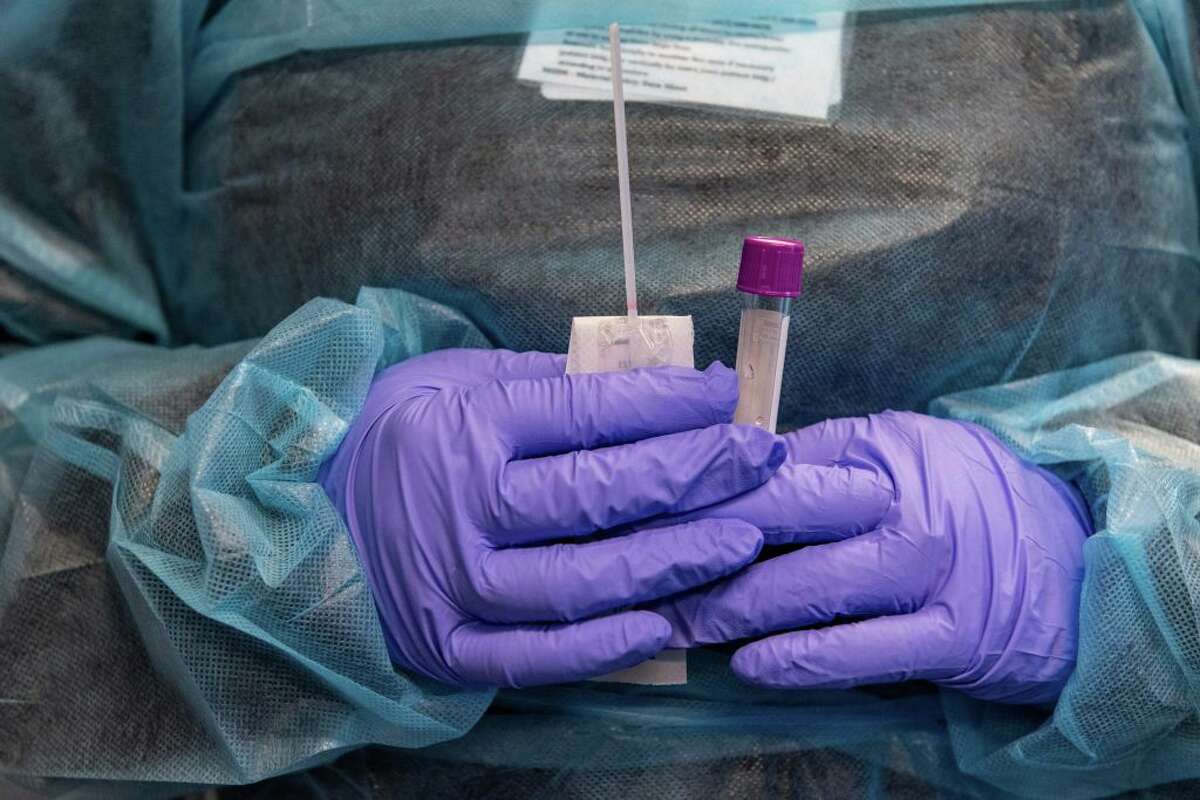 A medical worker prepares a Covid-19 PCR test at East Boston Neighborhood Health Center in Boston on Dec. 20, 2021. (Photo by Joseph Prezioso/AFP via Getty Images)