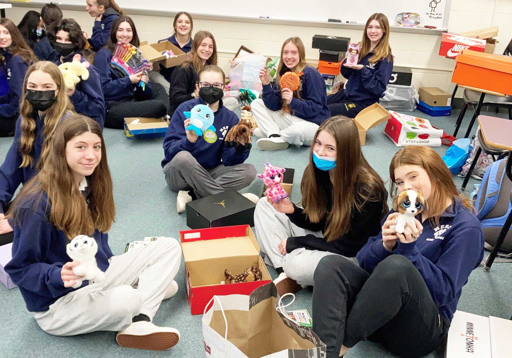 Mercy High School students assemble 500 boxes of toys, clothes for ...