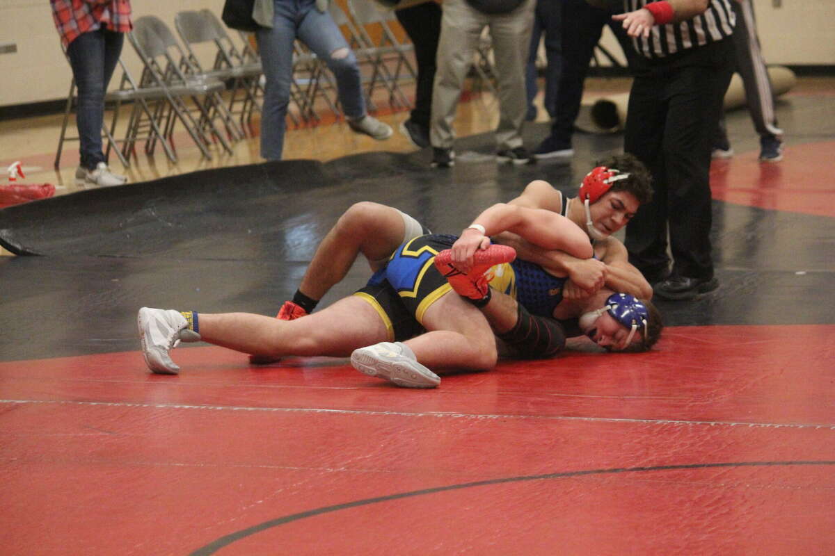 Reed City's Bryson Hughes (top) works on Evart's Sam Bailey during the season.