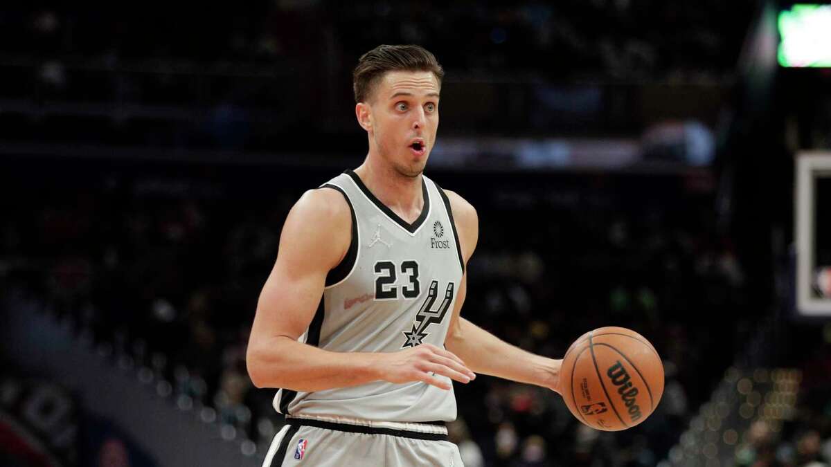 San Antonio Spurs’ Zach Collins moves the ball during an NBA basketball game against the Washington Wizards, Friday, Feb. 25, 2022, in Washington.