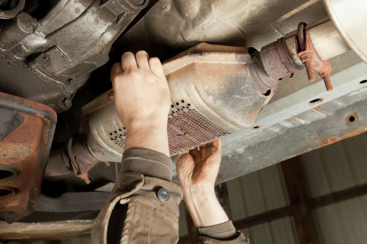 Part of a motor vehicle’s exhaust system, a catalytic converter, seen here being removed from a motor vehicle, transforms noxious gasses produced by internal combustion engines into harmless carbon dioxide and water vapor. Their linings contain rare metals that can fetch $20 to $240 from scrap-metal dealers.