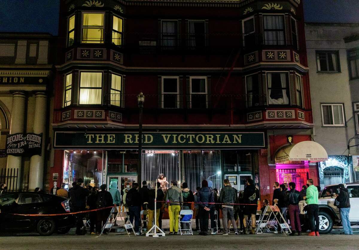 Drag performer Gia Regalado, 31, performs in the window of the Red Victorian on Haight Street in August 2020. After a long and eclectic history, Supervisor Dean Preston hoped to convert the building into housing for homeless youth.