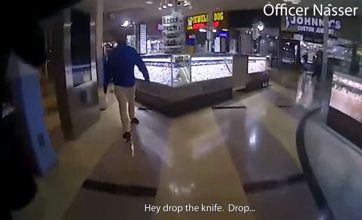 This still frame, taken from body-worn camera footage shared by the Houston Police Department, shows officer Mohammed Nasser was in the middle of giving commands to 36-year-old Czyz Harrison when he opened fire, killing the man inside the PlazAmericas Mall on Wednesday, Feb. 23, 2022.
