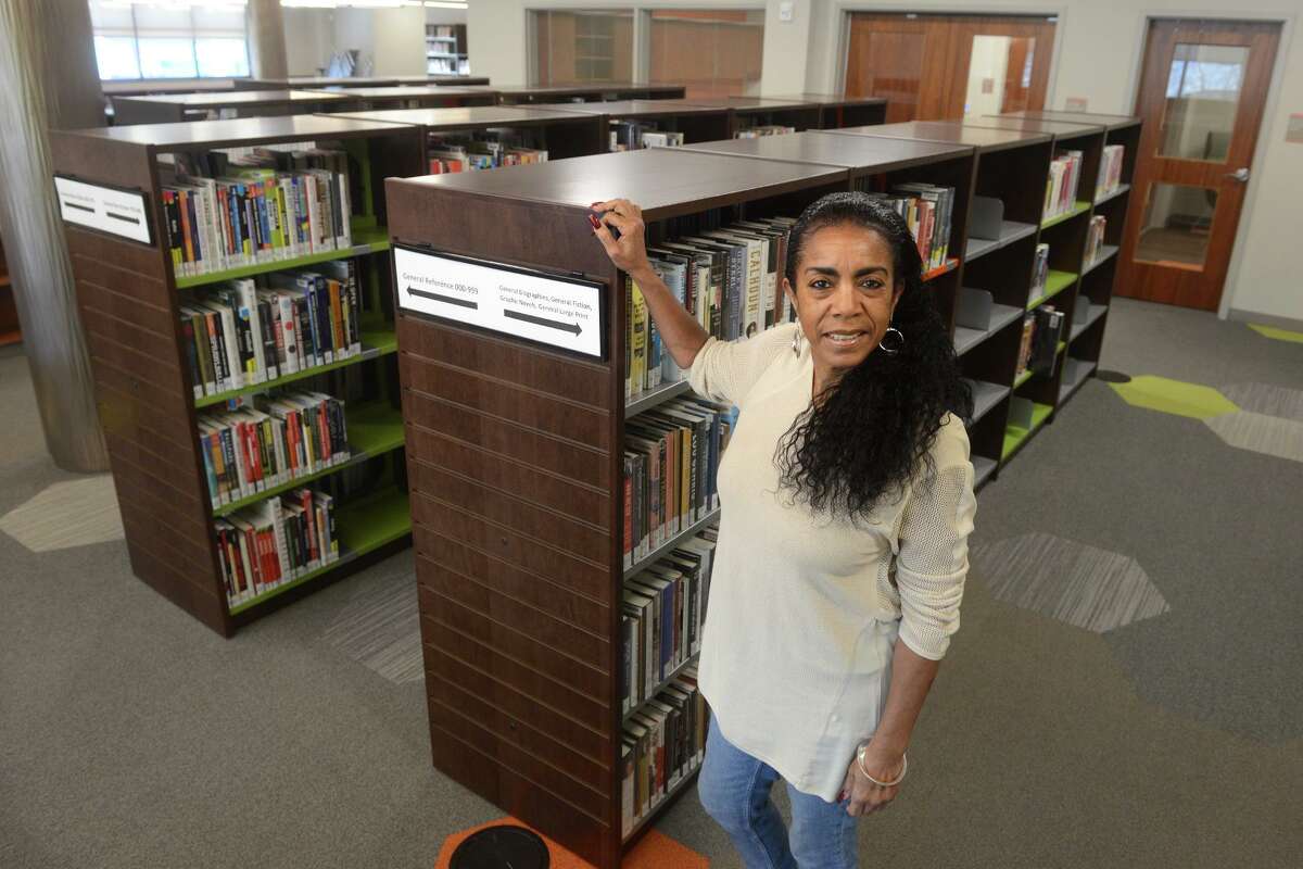 Branch manager Diane Brown poses inside the new Stetson Library in New Haven Tuesday.