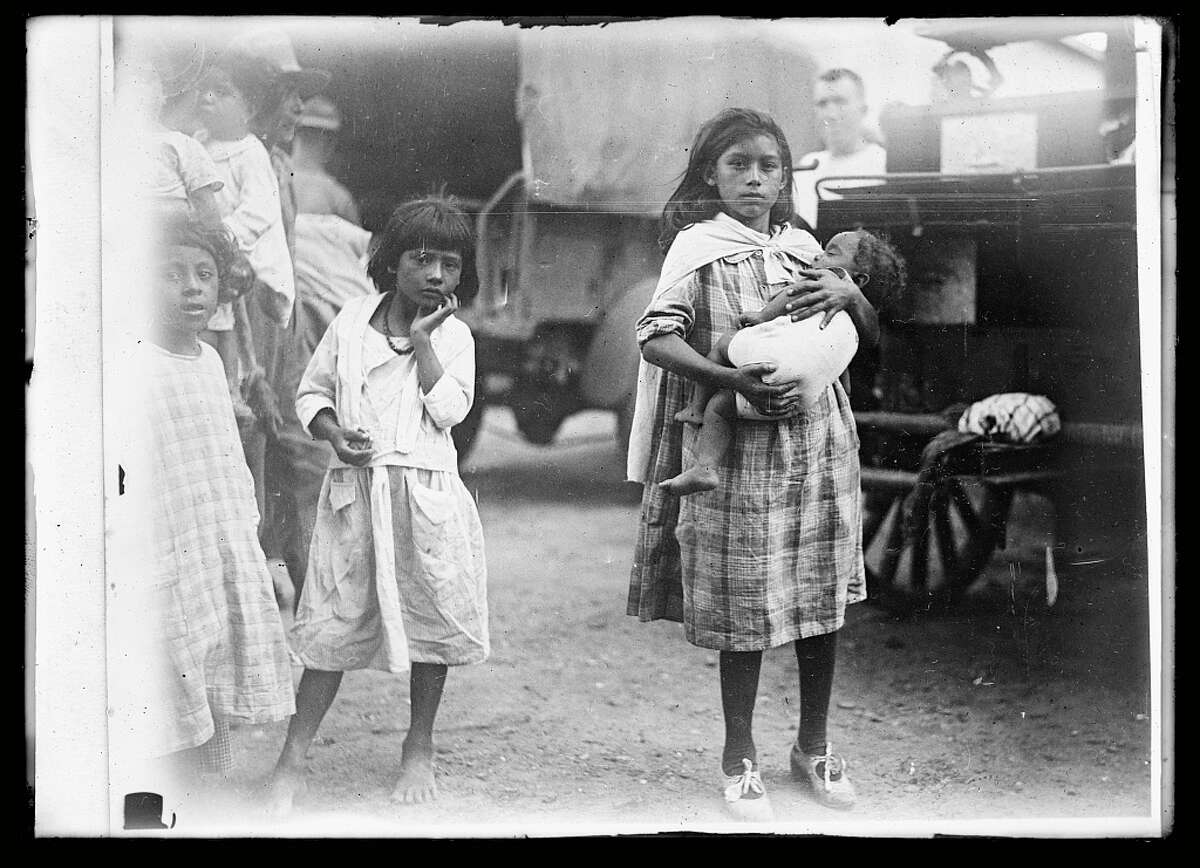 Photos taken by the American National Red Cross show the aftermath of the 1921 flood on the West Side of San Antonio. The original description on the September 22, 1921 photo calls the girls
