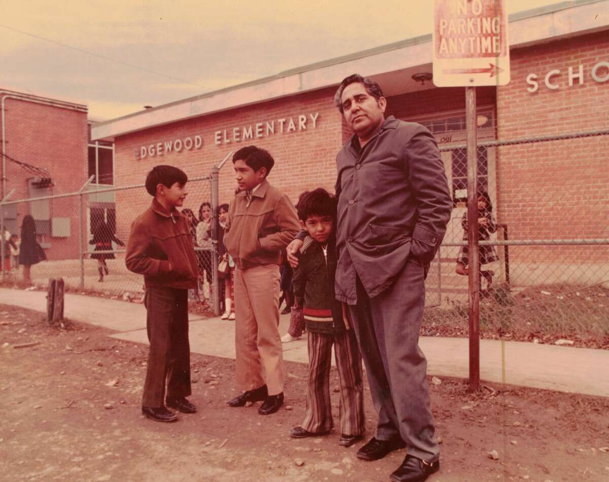 Demetrio Rodriguez's sons (left to right) Carlos, Alex, and James with their father outside Edgewood Elementary, which was eventually torn down to become Perales Elementary.