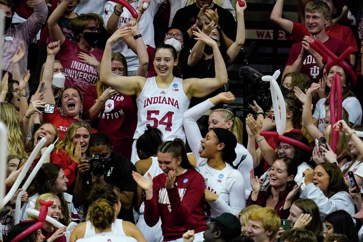 Indiana forward Mackenzie Holmes (54) along with her teammates celebrate in the stands after a 56-55 win over Princeton in the second round of the NCAA Tournament in Bloomington, Ind., on Monday.