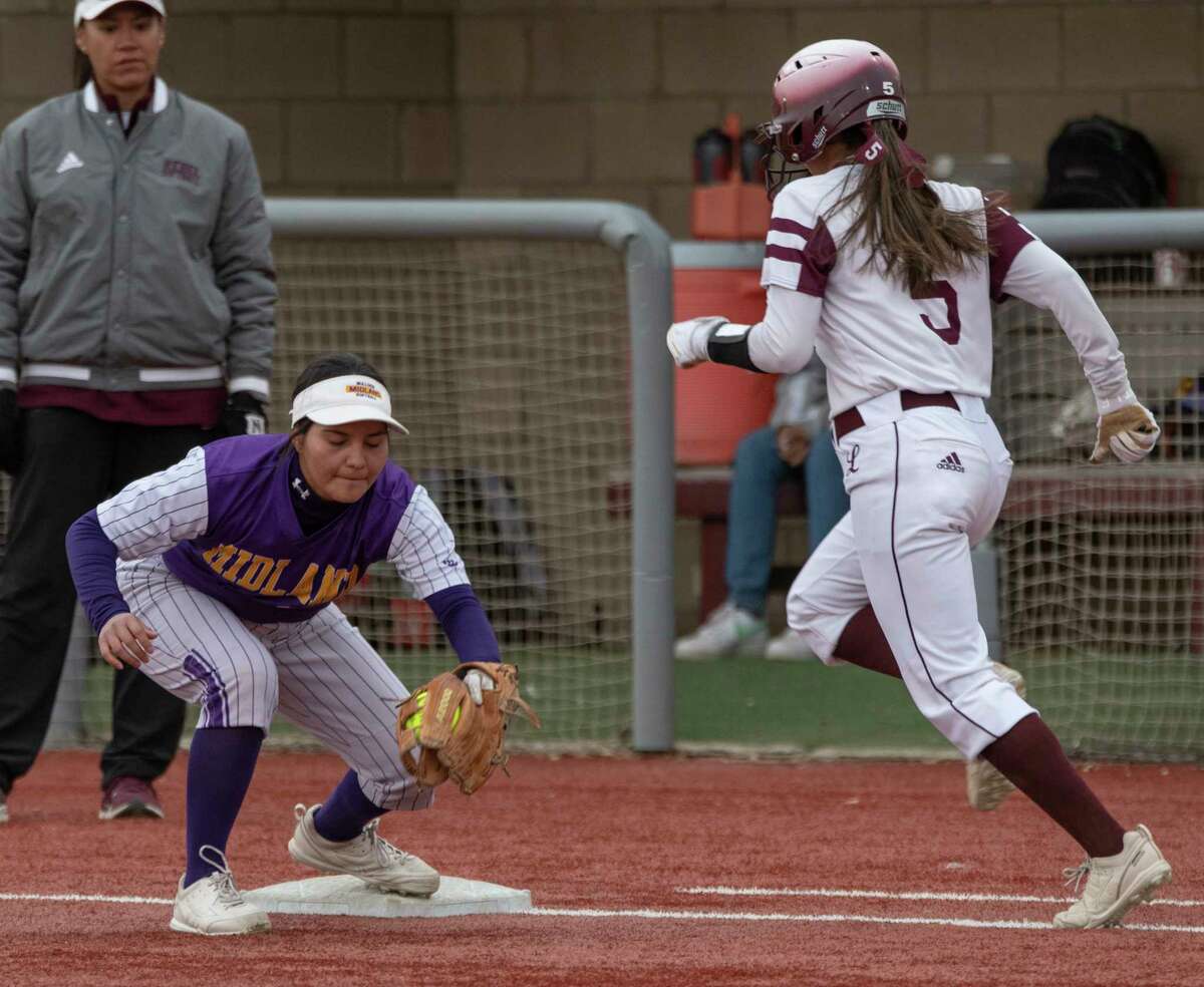 Midland High's Yesenia Rodriguez grips the ball for the out at first as Legacy High's Leann Torres races down the line 03/22/2022 at Gene Smith Field. Tim Fischer/Reporter-Telegram