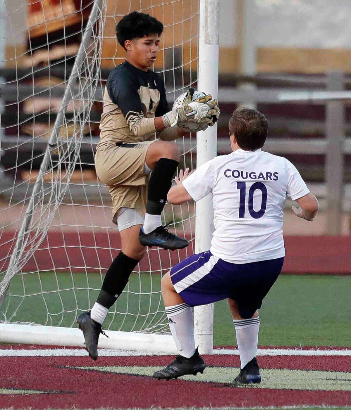 Magnolia West goalie Juan Delapaz (0) makes a stop in the first period of a high school soccer match at Magnolia High School, Tuesday, March 22, 2022, in Magnolia