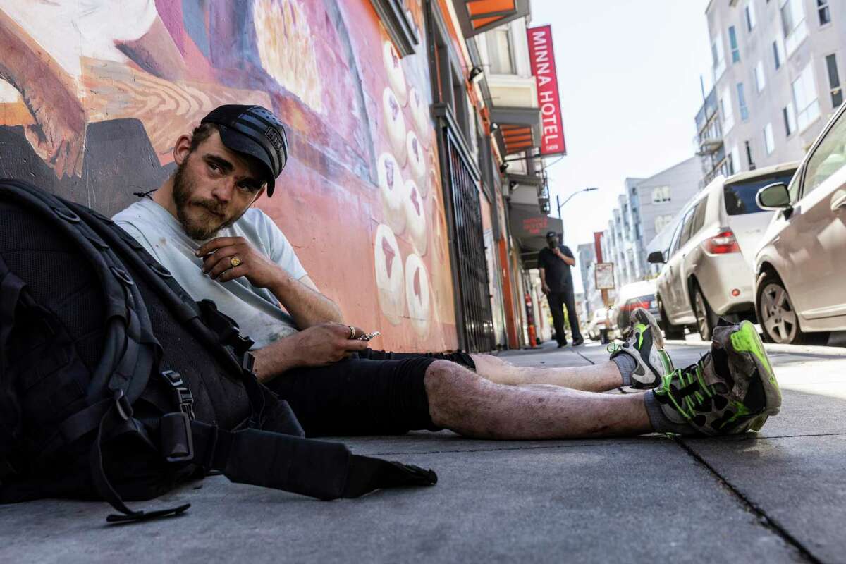 Peter Taylor, 23, relaxes on Minna Street near the shuttered Minna Hotel. Taylor, who is originally from San Jose, says he has been using fentanyl for about 10 months.