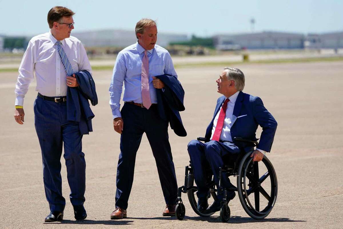 From left, Texas Lt. Gov. Dan Patrick, Attorney General Ken Paxton and Gov. Greg Abbott await the arrival of President Donald Trump at Dallas Love Field.