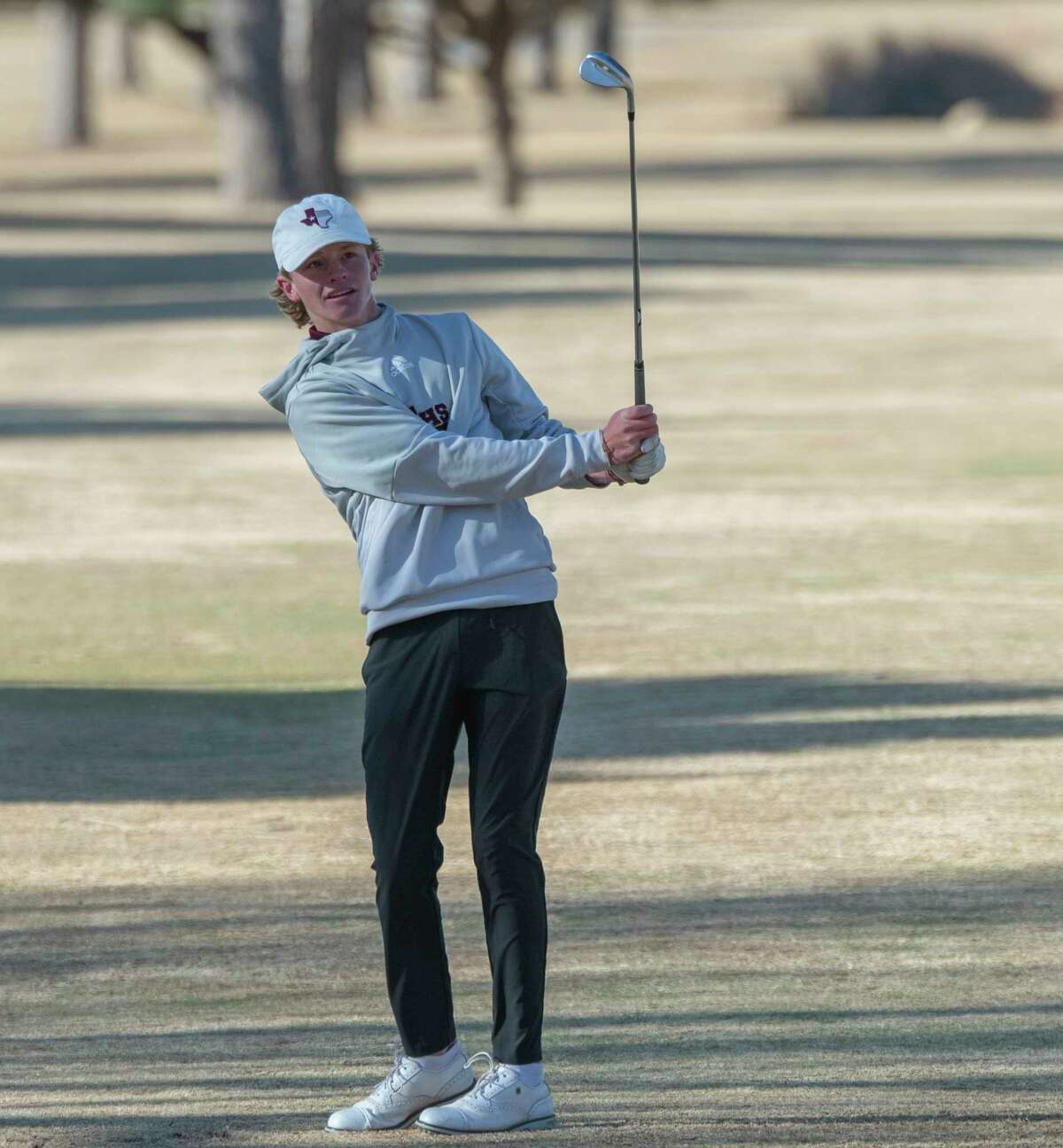 Legacy High's Spencer Widner chips toward the green 03/23/2022 during the District 2-6A golf tournament at Odessa Country Club. Tim Fischer/Reporter-Telegram