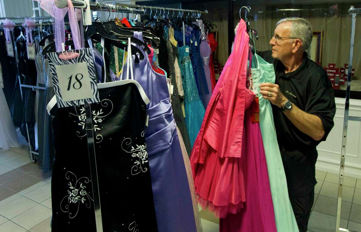 Howard Crockett helps organize dresses before the annual Priceless Gowns event at First Baptist Church, Thursday, March 22, 2018, in Conroe. This year’s Priceless Gowns event is set for April 7 and 8.