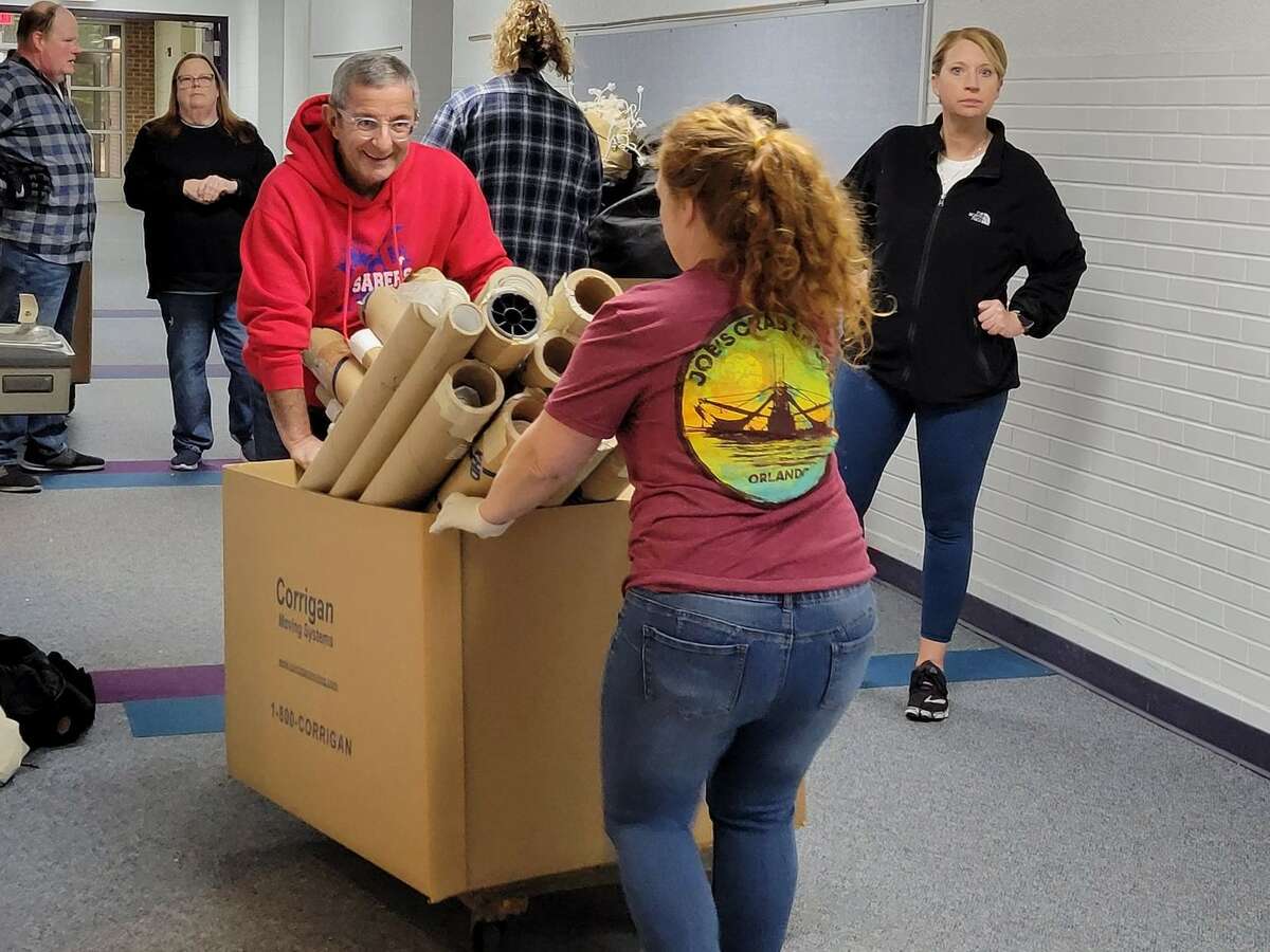 Manistee Civic Players members and volunteers work Saturday to move the troupe's props, wardrobe and equipment out of the former Wellston Elementary building.
