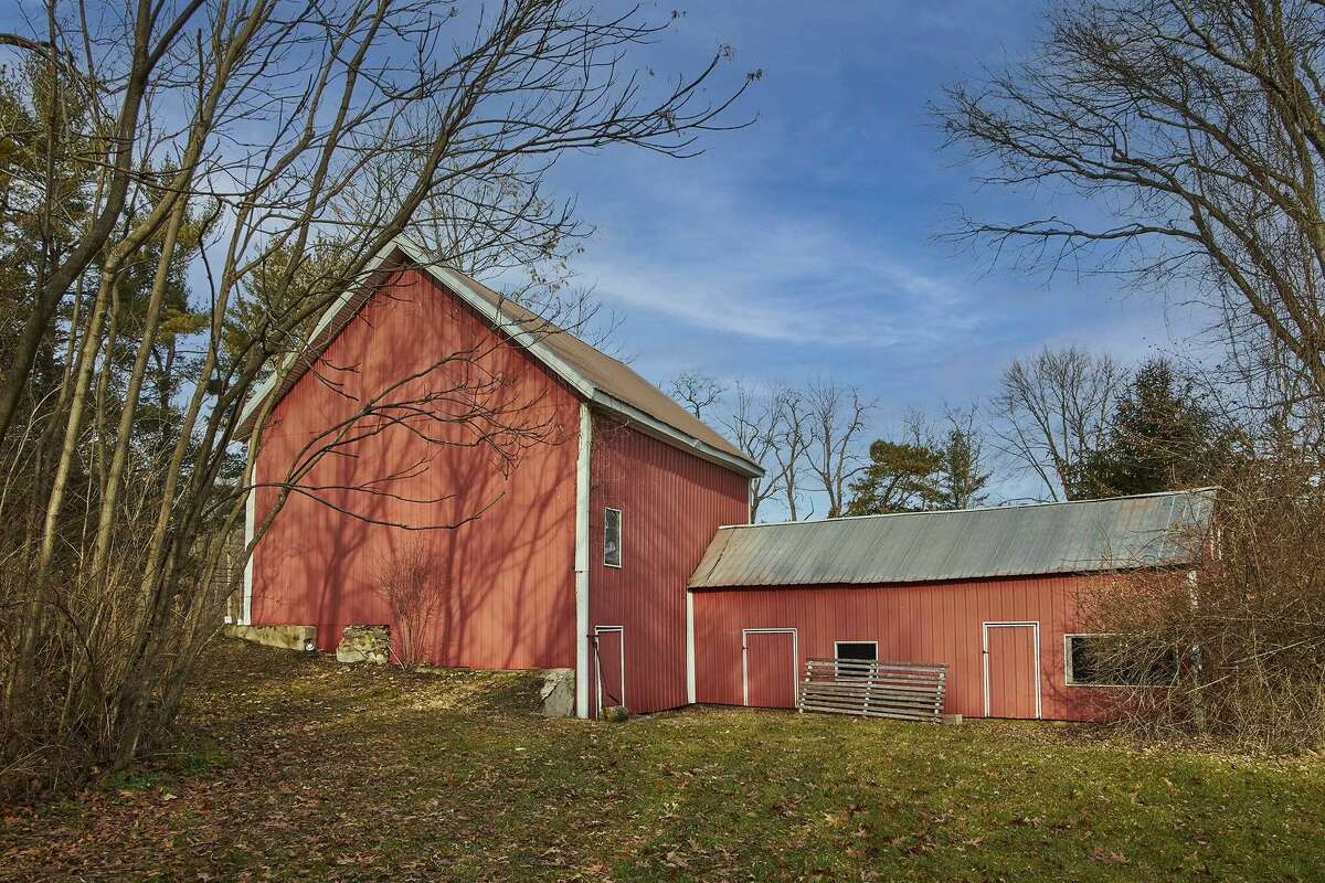 The 2-acre property includes a red barn with lofted second story space.