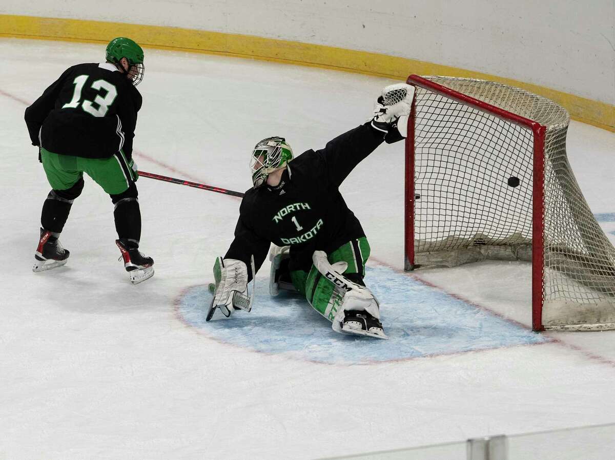 Carson Albrecht scores against goalie Kaleb Johnson as North Dakota hockey players practice for their game against Notre Dame in the NCAA game at the MVP Arena on Wednesday, March 23, 2022 in Albany, N.Y.