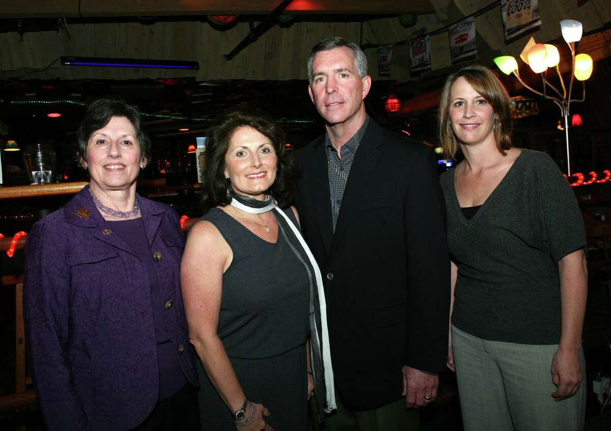Susan Hasslocher, far left, appears at a 2010 Alzheimer’s Association reception. She and her sister Caryn allege assets in the estate of their mother, Veva Hasslocher, should have gone to her children rather than her husband.
