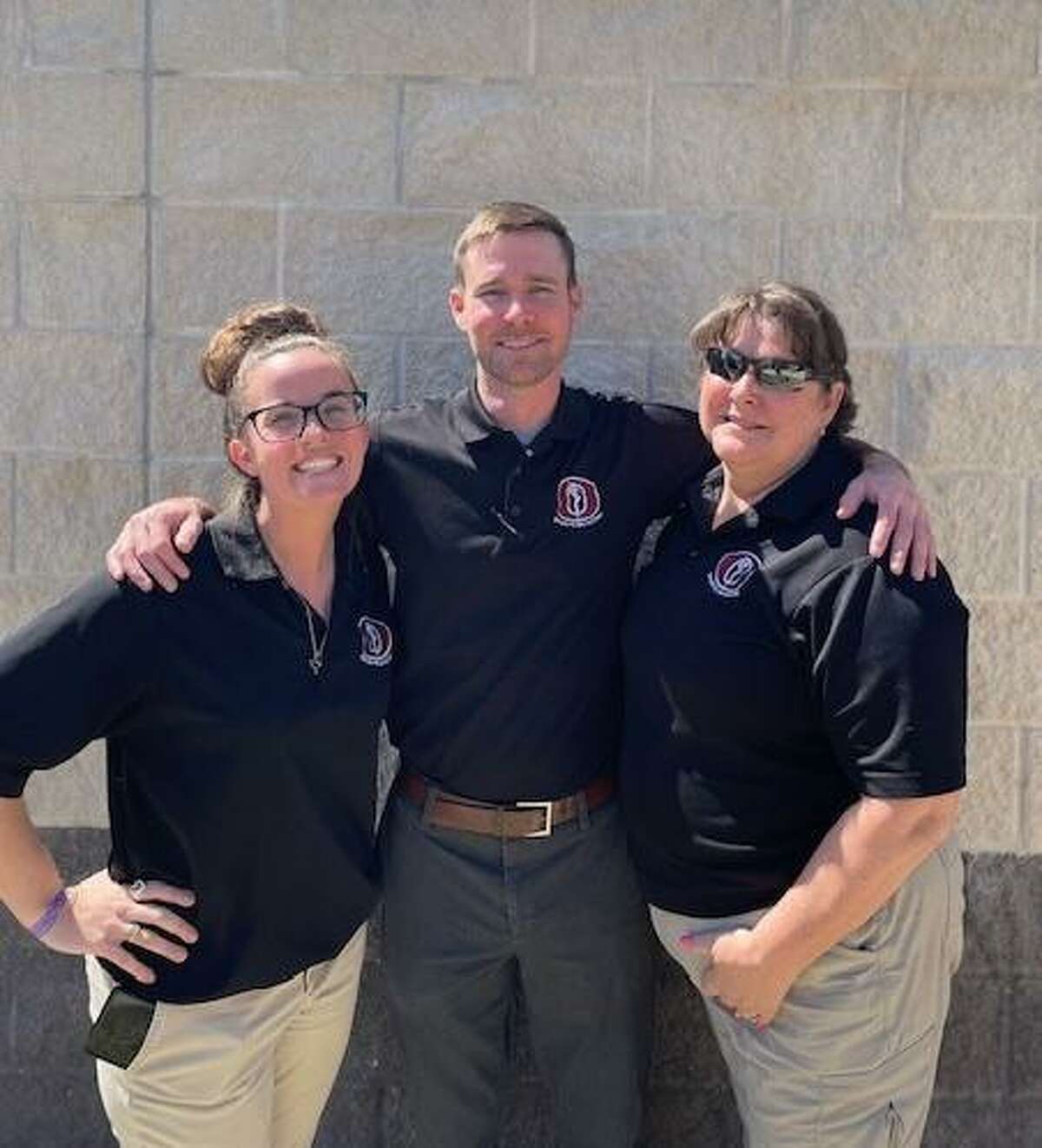 Head athletic trainer Will Ryan, center, and associate athletic trainers Catherine Windsor, left, and Jill Flowers provide care for students at Pearland High School.