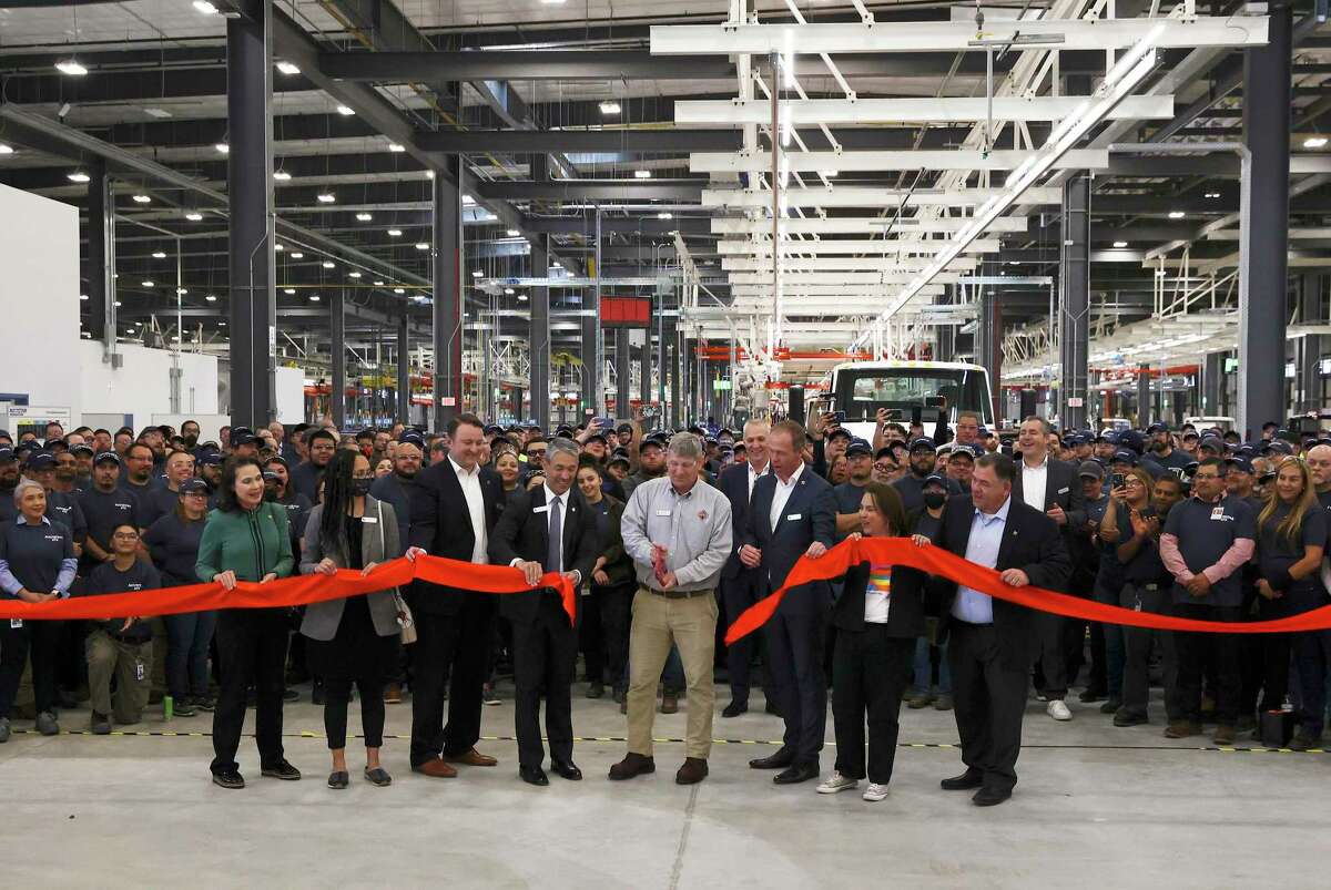 Navistar conducts a ribbon cutting ceremony with local government officials at its new factory on the South Side. The million square-foot facility is expected to produce heavy duty commercial trucks at a rate of 110 vehicles rolling off the line per day. The plant is equipped to produce diesel engine and fully electric vehicles according to Navistar officials. On hand were: Rod Spencer (center), San Antonio Plant Director, Navistar, Mayor Ron Nirenberg (fourth from left) and Mathias Carlbaum (third from right), President and CEO, Navistar.