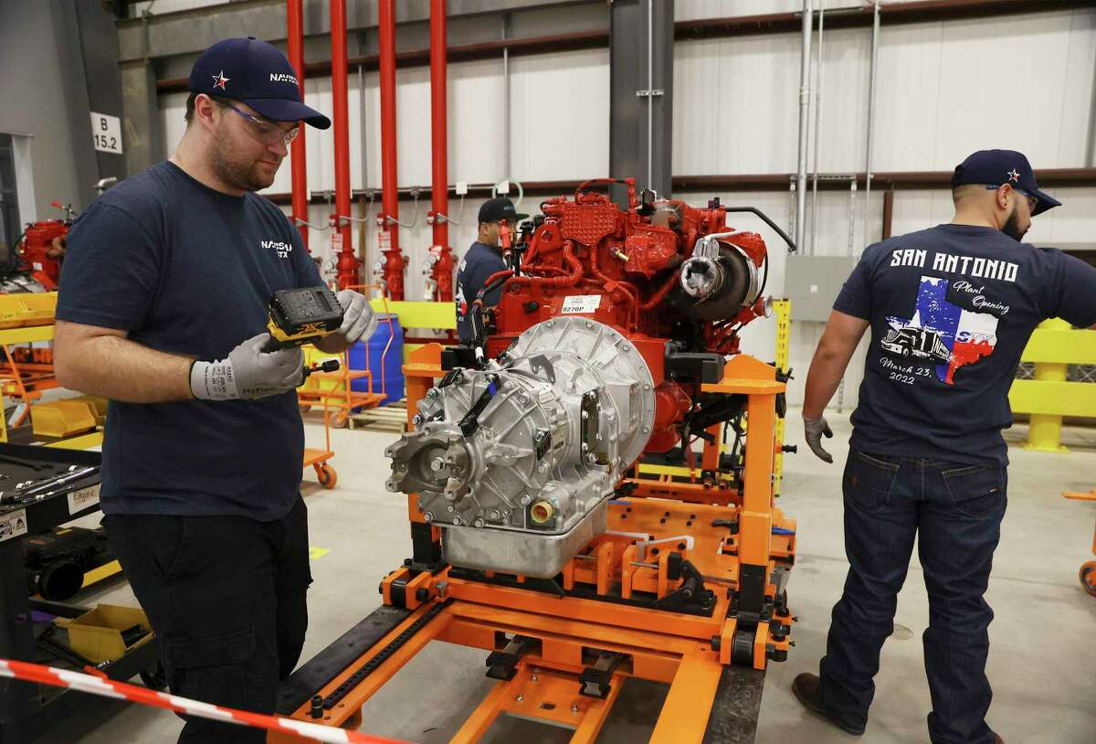 Navistar employees train on assembling a transmission as the company holds a ribbon cutting ceremony with local government officials at its new factory on the South Side. The million square-foot facility is expected to produce heavy duty commercial trucks at a rate of 110 vehicles rolling off the line per day. The plant is equipped to produce diesel engine and fully electric vehicles according to Navistar officials.