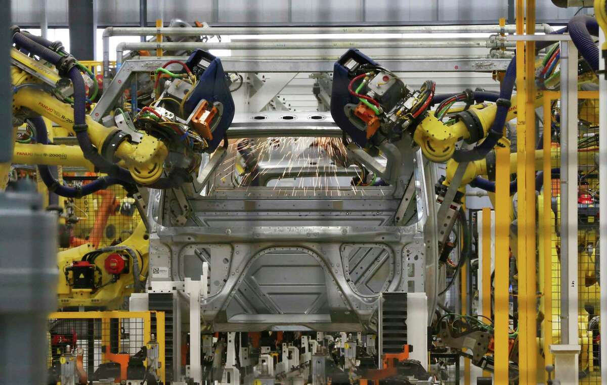 Robotic equipment weld together the cabin of a truck as Navistar holds a ribbon cutting ceremony with local government officials at its new factory on the South Side. The million square-foot facility is expected to produce heavy duty commercial trucks at a rate of 110 vehicles rolling off the line per day. The plant is equipped to produce diesel engine and fully electric vehicles according to Navistar officials.