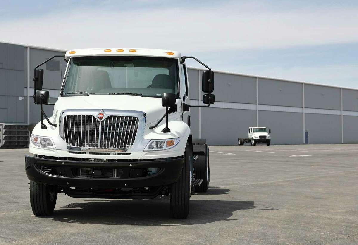 A finished commercial truck is shown on display as Navistar holds a ribbon cutting ceremony with local government officials at its new factory on the South Side. The million square-foot facility is expected to produce heavy duty commercial trucks at a rate of 110 vehicles rolling off the line per day. The plant is equipped to produce diesel engine and fully electric vehicles according to Navistar officials.