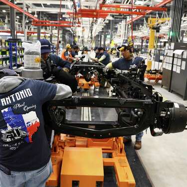 Navistar employees assemble a truck frame as the company holds a ribbon cutting ceremony with local government officials at its new factory on the South Side. The million square-foot facility is expected to produce heavy duty commercial trucks at a rate of 110 vehicles rolling off the line per day. The plant is equipped to produce diesel engine and fully electric vehicles according to Navistar officials.