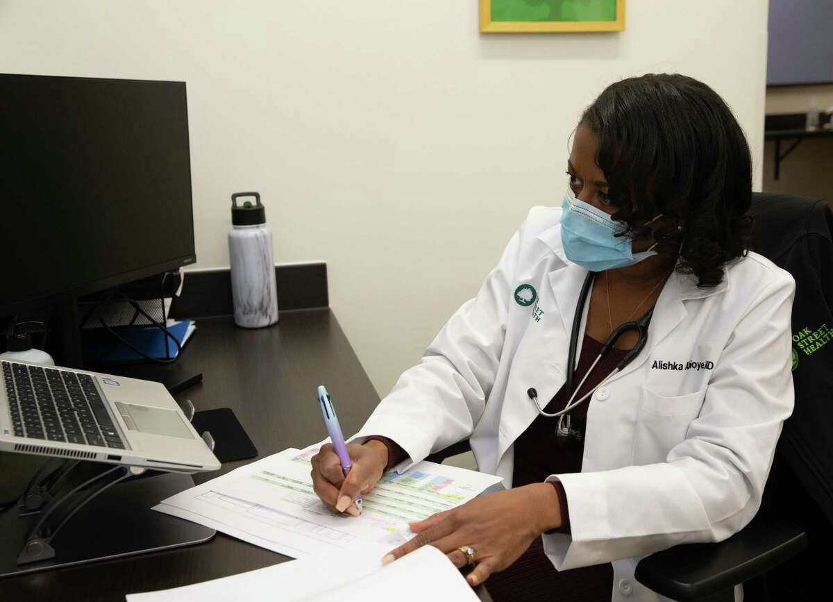 Dr. Alishka Abioye works on paperwork at Oak Street Health Wednesday, Feb. 23, 2022, in Houston.