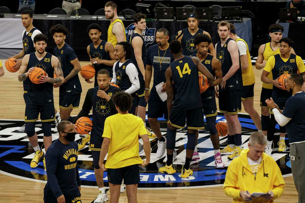The Michigan Wolverines break from a huddle during practice at AT&T Center in San Antonio, Texas, Wednesday, March 23, 2022. The 11-seed Wolverines will face the 2-seed Villanova Wildcats in the Sweet 16 on Thursday evening.