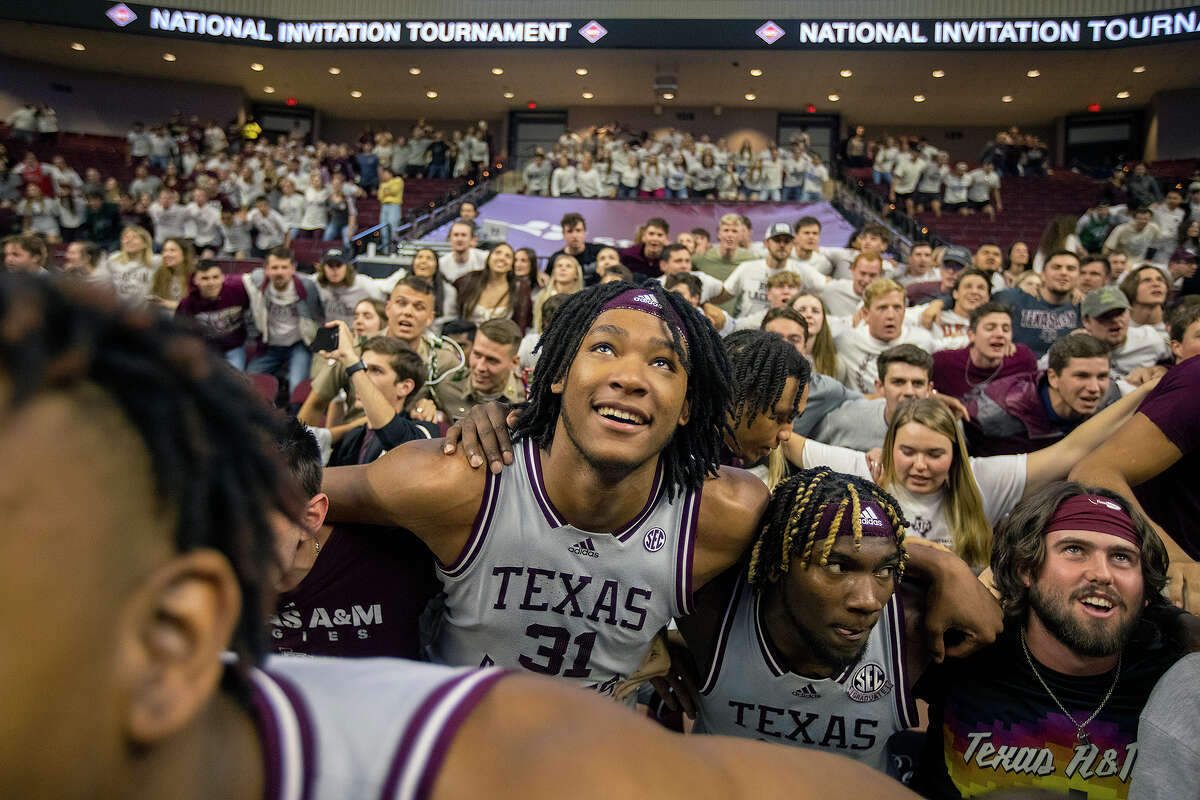 Texas A&M's Javonte Brown (31) and Tyrece Radford take part in the Aggie War Hymn with fans following their victory over Wake Forest in the NIT quarterfinals Wednesday night in College Station.