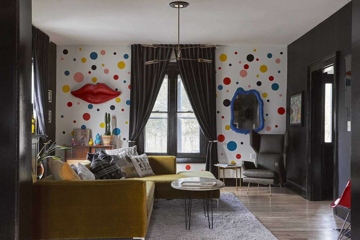 The main floor sitting room contrasts the home’s darker colors with a pop of rainbow polkadots.