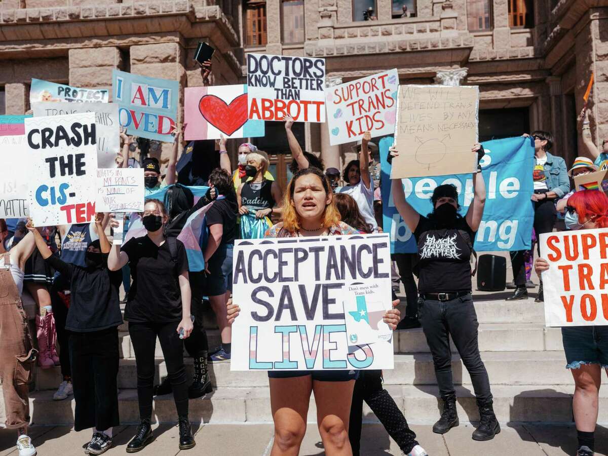 Demonstrators protest a Texas policy to regard gender-affirming treatments for transgender youth as child abuse, at the State Capitol in Austin, March 1, 2022.
