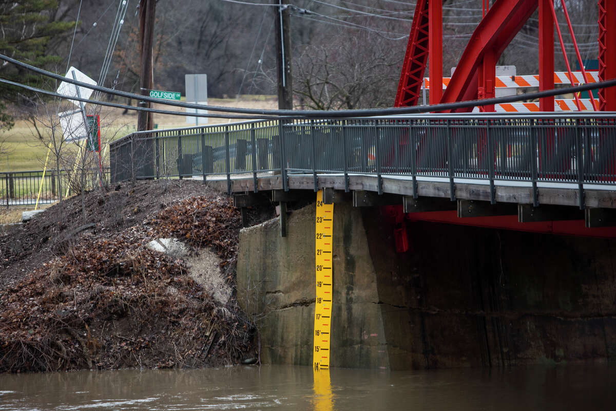 The water level of the Tittabawassee River nearly reaches 14 feet Thursday, March 24, 2022 near Golfside Drive. The river is expected to crest at around 22 feet on Saturday, according to the National Weather Service.