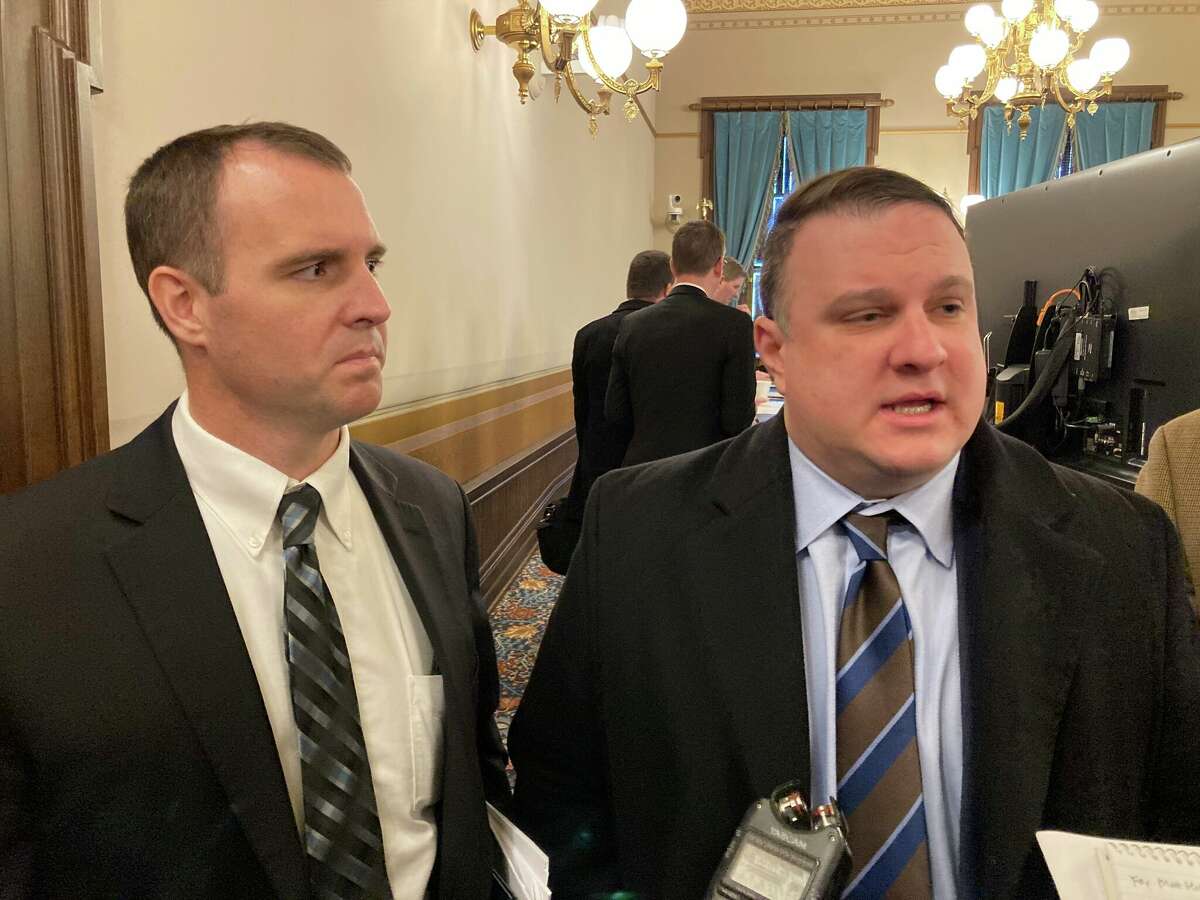 House Appropriations Committee Chair Thomas Albert, R-Lowell, left, and House Tax Policy Committee Chair Matt Hall, R-Marshall, right, speak with reporters on Thursday, Feb. 24, 2022, at the state Capitol in Lansing. 
