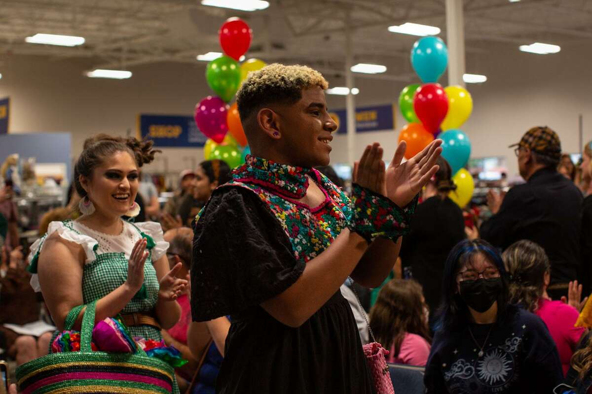 Hannah Siller (left) and Avery Wiley-Ramsey (right) clap during the final walk in the Fiesta Sustainable Fashion Show, where students from the Stevens High School Entrepreneurship/Fashion Program work with Goodwill to learn about retail and design their own garments. (Kaylee Greenlee Beal/Contributor)