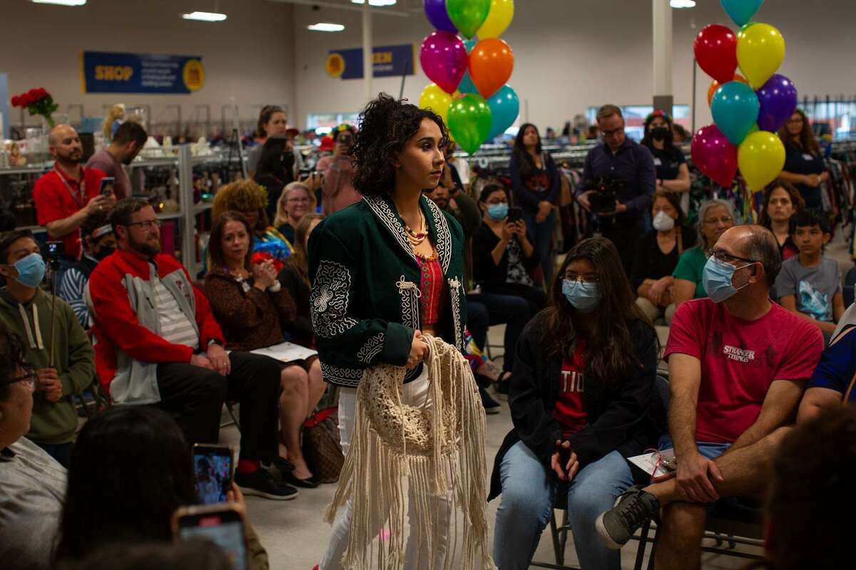 Victoria Garcia walks in the Fiesta Sustainable Fashion Show at the Goodwill store on Potranco Road. Stevens High School students design their own garments and volunteer at a Goodwill store to learn about retail. . (Kaylee Greenlee Beal/Contributor)