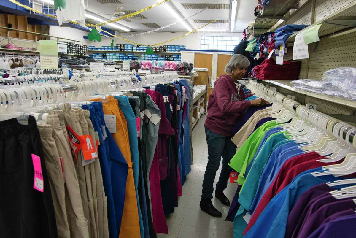 B. Lodge & Co. employee Demetra Haizlip-Brown-Hoke organizes clothes on a rack Monday, March 14, 2022 in Albany, NY