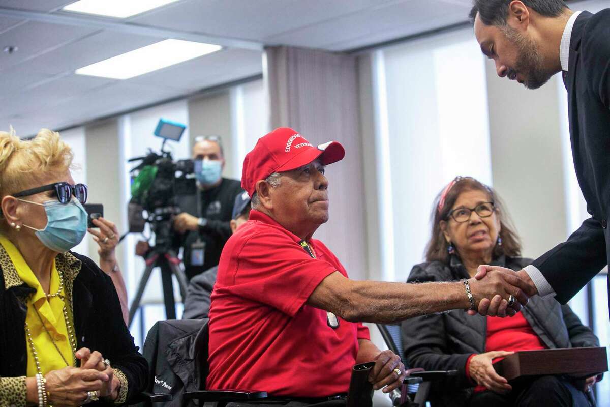 Robert Perez, the son of Army Pfc. Marcos H. Perez, who was killed in action in Korea in 1951, shakes hands with U.S. Rep. Joaquin Castro after the family received medals posthumously awarded to the San Antonio soldier.