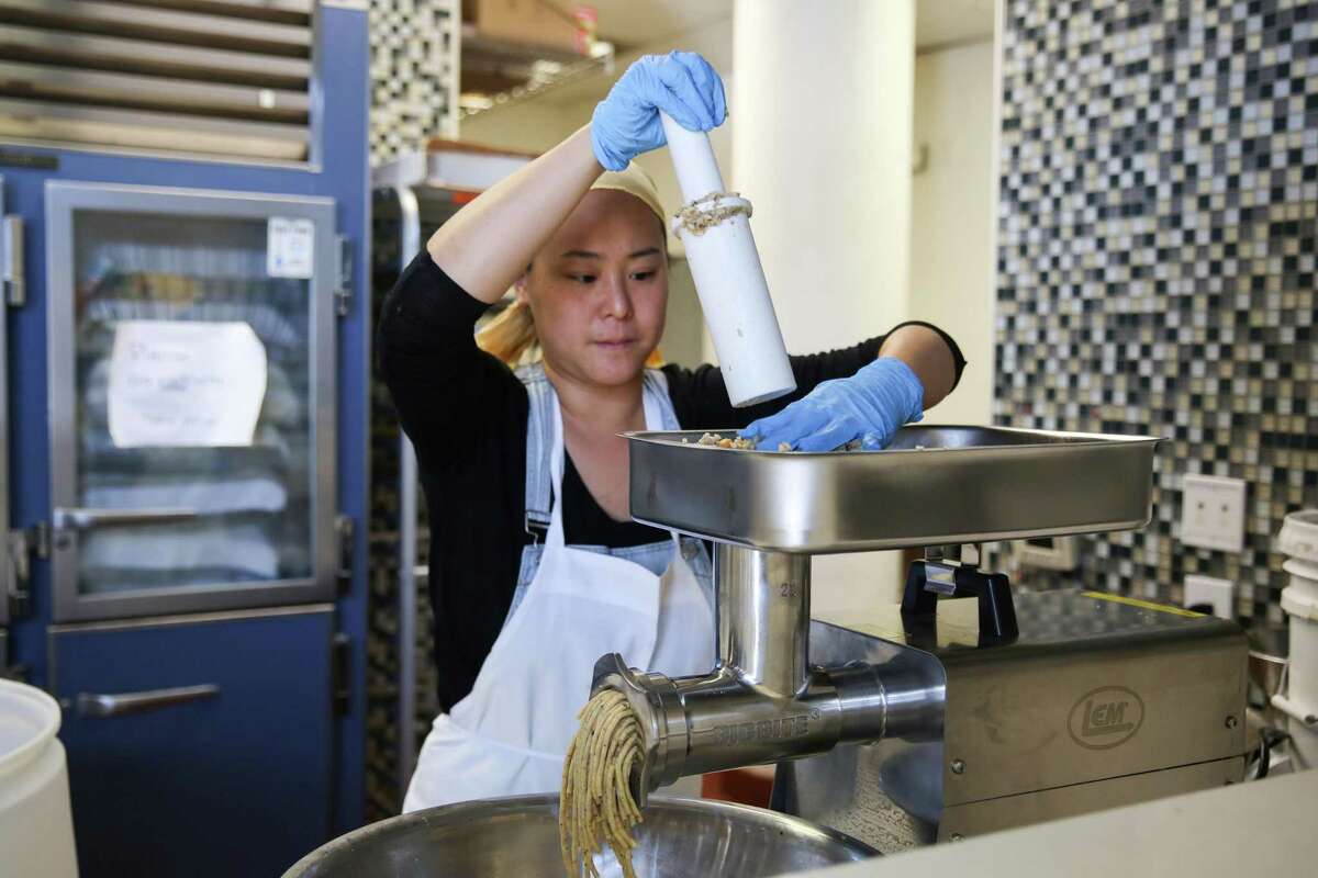 Eleana Hsu pushes her miso mixture through a meat grinder. Her fermentation outfit, Shared Cultures, has emerged as a darling of the San Francisco food industry.