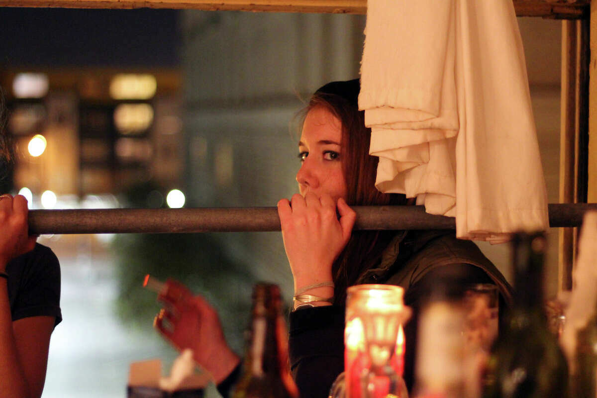 Molly Evans smokes a cigarette on the fire escape. 