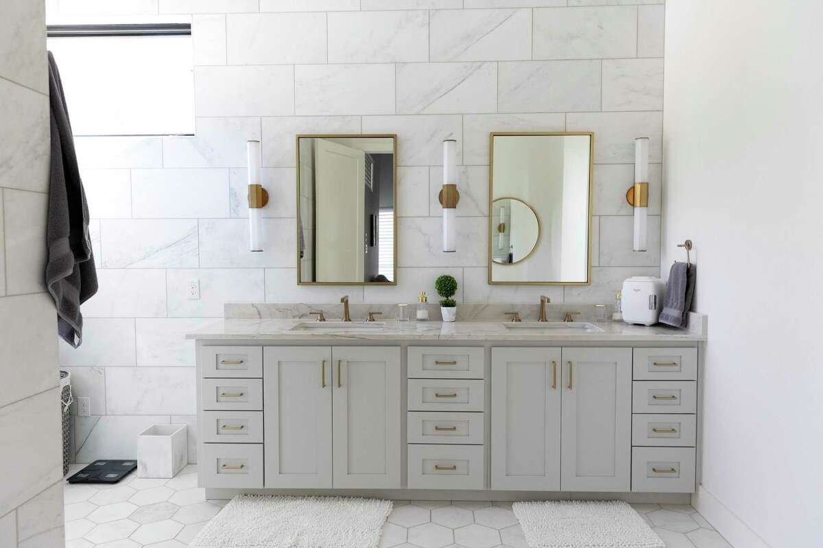 In the bathroom, large marble hex floor tiling and huge, 12-by-24-inch rectangular tiles on the walls give the bathroom an elegant richness.