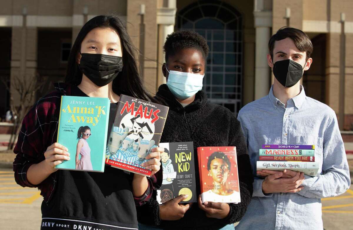 Voters for Tomorrow student leaders Cynthia Zhang, from left, Amisa Ombito and Cameron Samuels pose for a photograph with literature covering they distributed to their peers Friday, Feb. 18, 2022, at Seven Lakes High School in Katy. Katy ISD is now reviewing whether “Maus” and “Maus II,” graphic novels about the holocaust that the students handed out, are appropriate for its school libraries.