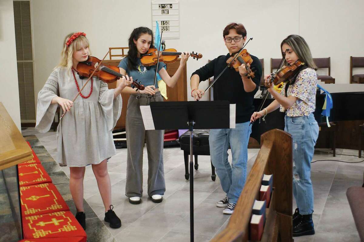 Samuel Savanich, second from right, is a a junior at Clear Falls High School who has led the project for a fund-raising recital to aid Ukrainian refugees. Practicing with him for are Ukrainian refugee Anna Kovalchuk, left, and Clear Falls students Anisa Roshan-Zamir and Kaylie Rodriguez.