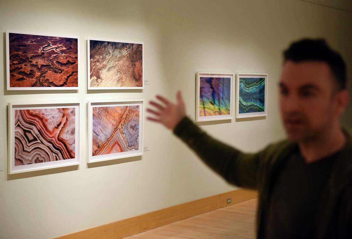 Photographer Jonathan Pozniak shows his aerial desert photography, top, paired with Eric Seplowitz' marco photography, below, at the "An Uncommon Planet" exhibit at Greenwich Library's Flinn Gallery in Greenwich, Conn. Tuesday, March 22, 2022. The show features photography by Jonathan Pozniak and Eric Seplowitz, displaying the beauty and fragility of our planet both up close and from afar.